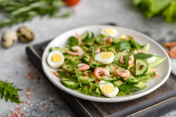 Salad with shrimp, avocado, cucumber, pumpkin seeds and flax seeds with olive oil