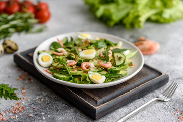 Salad with shrimp, avocado, cucumber, pumpkin seeds and flax seeds with olive oil