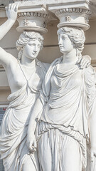 Portrait of balcony support statues of young and naked sensual Roman renaissance era women in...