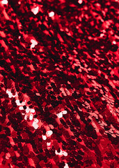 Red sequins fabric close up texture background