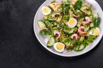 Salad with shrimp, avocado, cucumber, pumpkin seeds and flax seeds with olive oil
