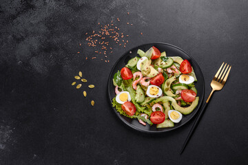 Salad with shrimp, avocado, cucumber, pumpkin seeds and flax seeds with olive oil