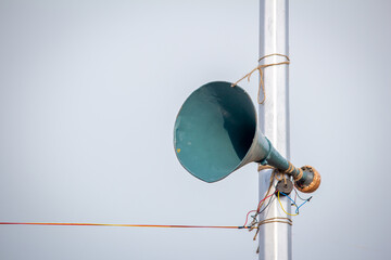 A loudspeaker attached to the lamp post along the Marina Beach for public announcements, Chennai,...