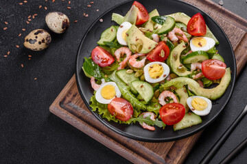 Fototapeta na wymiar Salad with shrimp, avocado, cucumber, pumpkin seeds and flax seeds with olive oil