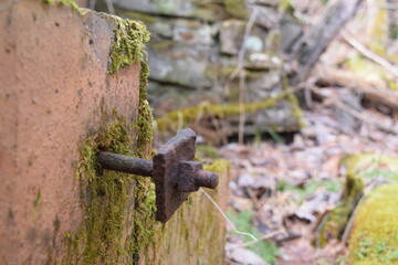 Closeup of nut and bolt on the ruins of an abandoned building