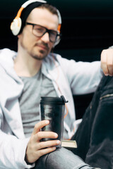 Close-up of man having takeaway coffee.