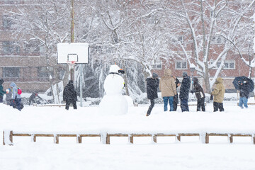 People enjoying the historical Snowtorm over Madrid city, Spain.
