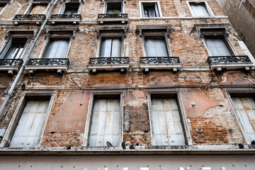 A decaying and crumbling apartment building in the historic center of Venice, Italy.