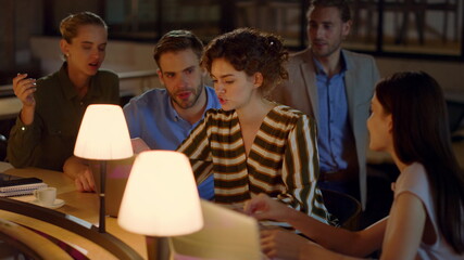 Young people looking computer screen in office.Business team discussing work.