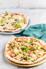 Homemade stone and mold pizzas with fresh vegetables and muzzarella