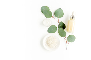 Fototapeta na wymiar Eucalyptus essential oil, eucalyptus leaves on white background. Natural, Organic cosmetics products. Medicinal plant. Natural Serums. Flat lay, top view.