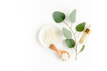 Obraz na płótnie Canvas Eucalyptus essential oil, eucalyptus leaves on white background. Natural, Organic cosmetics products. Medicinal plant. Natural Serums. Flat lay, top view.
