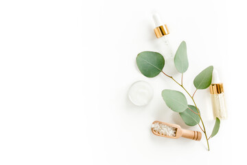 Eucalyptus essential oil, eucalyptus leaves on white background. Natural, Organic cosmetics products. Medicinal plant. Natural Serums. Flat lay, top view.