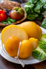 Cheese collection, Italian cheeses provolone, caciocavallo, scamorza made from sheep or cow milk in South Italy, white and yellow smoked.
