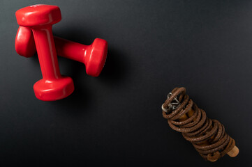 Fitness dumbbells and jump rope. Items for keeping fit.