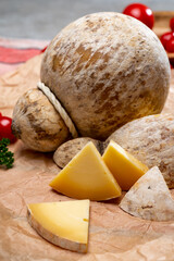 Italian semi hard matured caciocavallo cheese, handmade and aged in natural underground caves in...