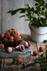 Fresh red lychee fruits.  Fresh organic lychee fruit on a rustic wooden background.