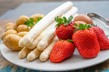 Spring in Netherlands, high quality Dutch white asparagus, washed and peeled on board with fresh...