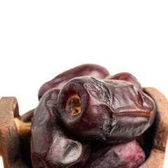 Dried organic date fruits in a bowl, isolated on white background