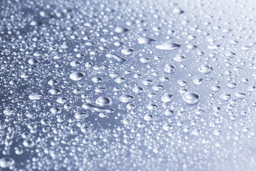 Drops of water on a gray background closeup