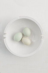 organic eggs in white bowl