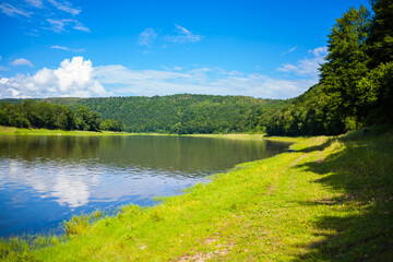 Beautiful view over the river Dniester and riverbank on a sunny summer's day. Outdoor recreation. Fishing adventures, carp fishing. Swimming, summer vacation, outdoor activities, place for picnic.