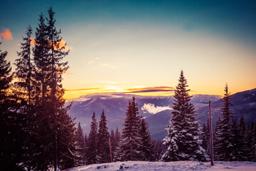 Beautiful dawn in the winter snow-covered mountains and amazingly beautiful clouds