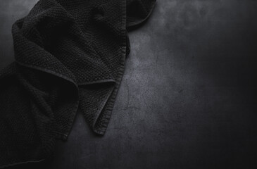 Black table cloth on dark moody concrate background