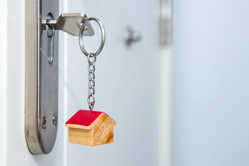 house or apartment door with keys and house key ring