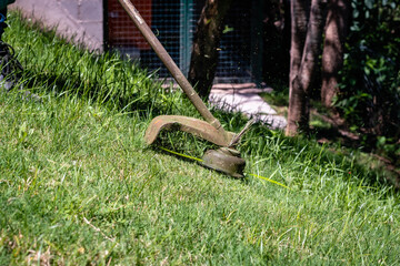 close-up of lawn mower in green park in summer gardener cordoba argentina