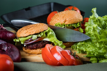 Delicious burger. Still life of vegetables and hamburger.
