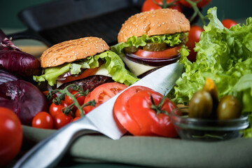 Delicious burger. Still life of vegetables and hamburger.