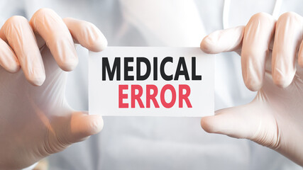 Doctor holding a card with text MEDICAL ERROR