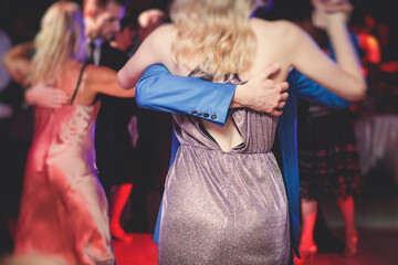 Couples dancing traditional latin argentinian dance milonga in the ballroom, tango salsa bachata...
