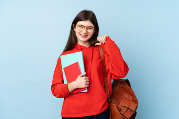 Obraz premium Young Ukrainian teenager student girl holding a salad over isolated blue background proud and self-satisfied