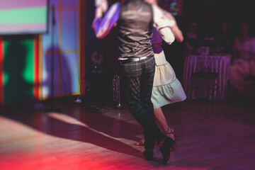 Couples dancing traditional latin argentinian dance milonga in the ballroom, tango salsa bachata...