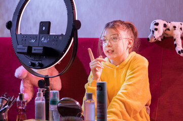 The girl tells something to the camera. The blogger explains something to the camera. Video blogger.