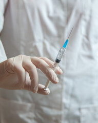 medical injection syringe in the nurse's hand