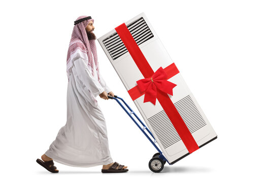 Saudi Arab Man Pushing A Hand-truck With A Self Standing Ac Unit Tied With A Bow