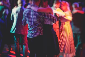 Fototapete Rund Couples dancing traditional latin argentinian dance milonga in the ballroom, tango salsa bachata kizomba lesson in the red lights, dance festival © tsuguliev