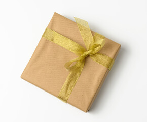 box wrapped in brown kraft paper and tied with golen ribbon