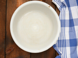 large plastic empty bowl on brown wooden table