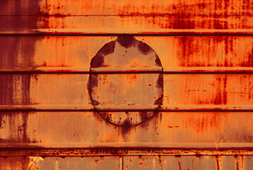 An old rusty sheet of metal. The texture of sheet metal, the grunge style. Empty orange background - 405627887