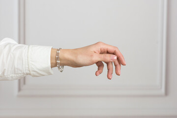 Fototapeta na wymiar Woman with a silver bracelet on her hand