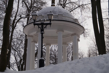White gazebo in a snow-covered park