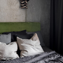 Fototapeta na wymiar Close-up on bed with green velour headboard