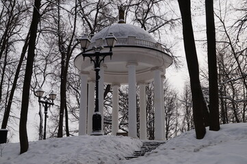 White gazebo in a snow-covered park