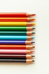 Set of colorful pencils on the warm white background.