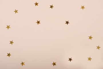 beige background with stars. Creative flat lay with copy space.