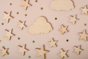 wooden stars and clouds on a beige background
